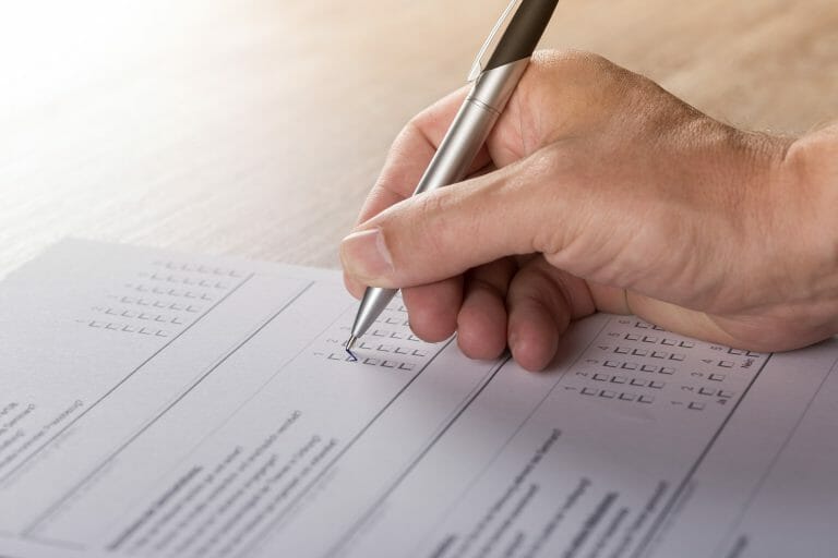 Hand filling a form
